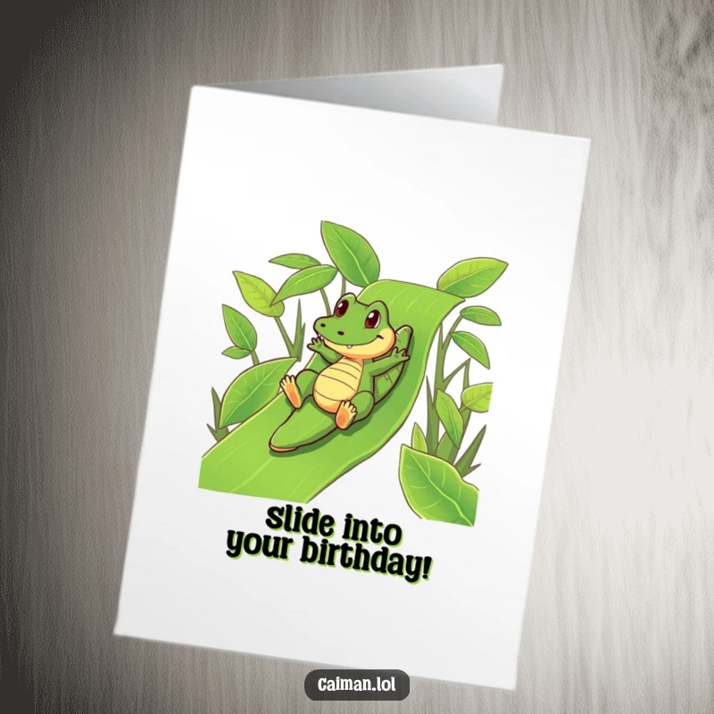 Funny free printable birthday card with a caiman playfully sliding down a vibrant green leafy slide, fun birthday wish.