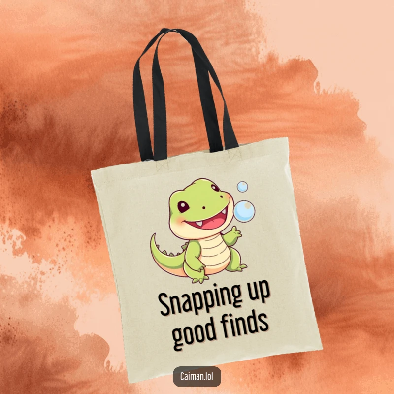 Funny tote bag showing a cheerful, toothy reptile with a stubby tail playfully snapping at a tiny floating bubble, making errands more fun.