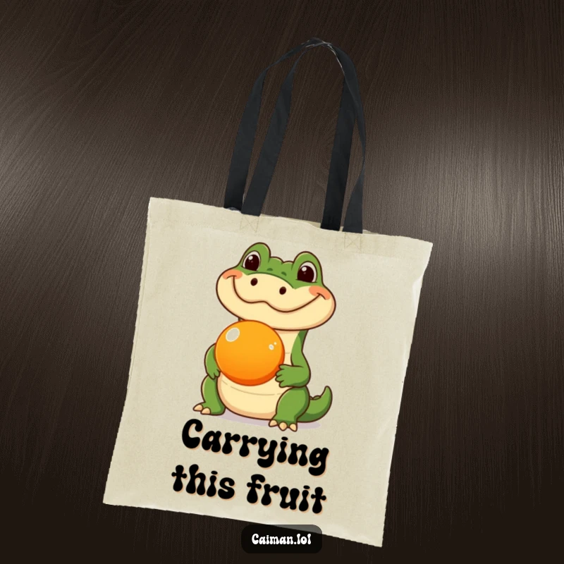 Funny Caiman Tote Bag, a reusable bag showcasing a caiman with a silly expression, balancing a round orange fruit on its snout, great for carrying items.