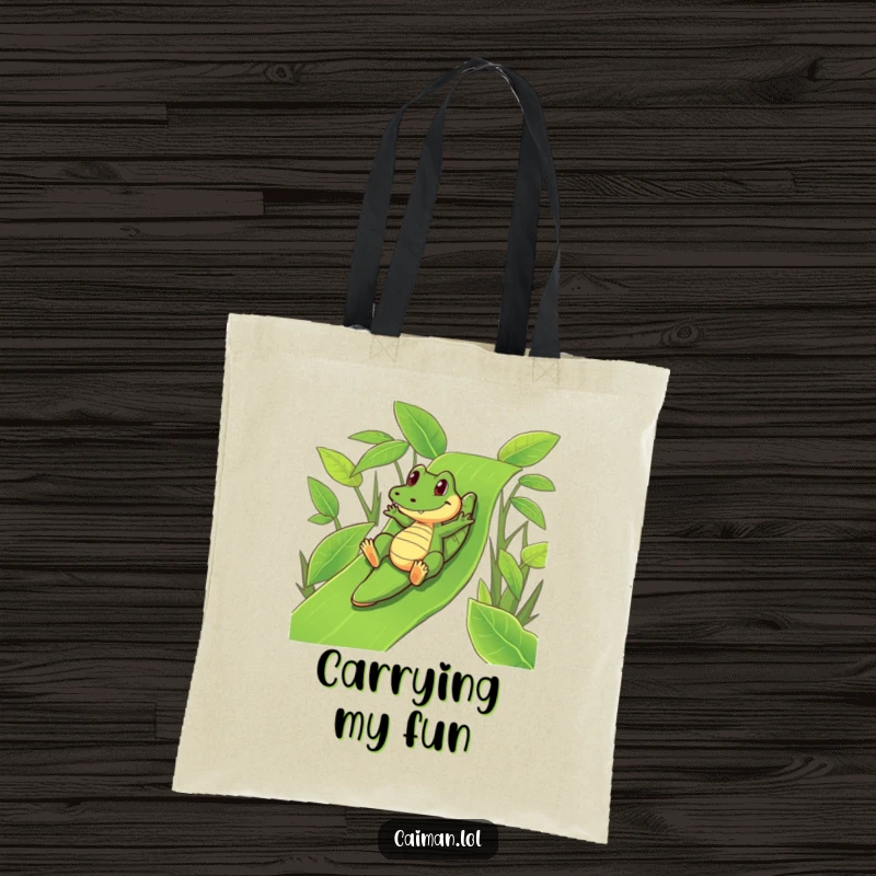 Funny Caiman Tote Bag: A fun tote featuring a funny caiman playfully sliding down a vibrant, green leafy slide.